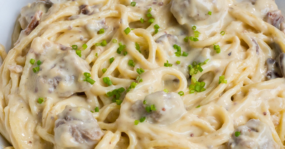 German Spaghetti with Bratwurst, Bacon, and Creamy Cheddar Sauce